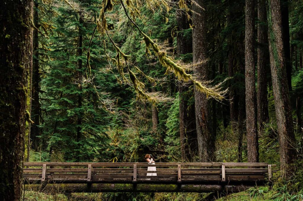 Couple taking photos at waterfall near Olympic National Park
